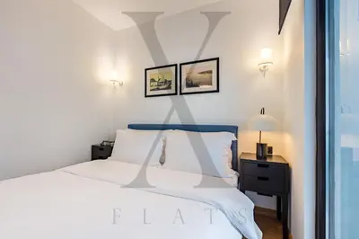 a bedroom with a white bed and a window at X Flats Kaiser in Istanbul