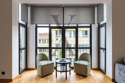 a room with two chairs and a table and large windows at X Flats Kaiser in Istanbul