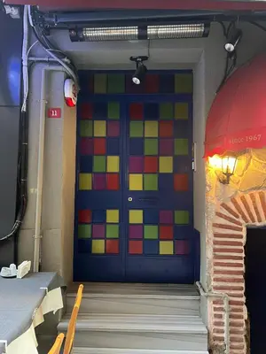 a colorful door in a room with a staircase at ŞAHİN PERA SUİT 1 stylish 2Br 3Ac apartment near Istiklal street in Istanbul