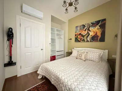 a bedroom with a bed and a painting on the wall at ŞAHİN PERA SUİT 1 stylish 2Br 3Ac apartment near Istiklal street in Istanbul