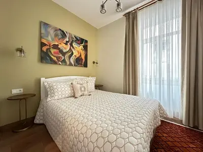 a bedroom with a white bed and a large window at ŞAHİN PERA SUİT 1 stylish 2Br 3Ac apartment near Istiklal street in Istanbul