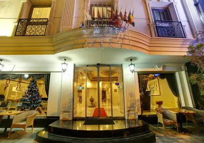 a lobby with a christmas tree and a table and chairs at Halifaks Hotel in Istanbul