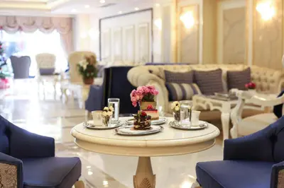 a living room with a table with flowers on it at Halifaks Hotel in Istanbul
