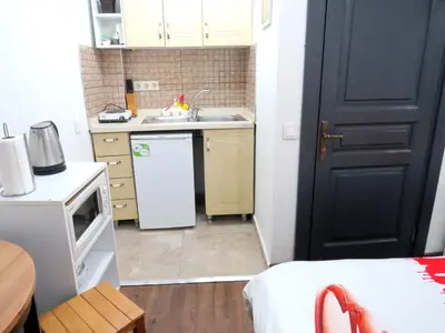 a small kitchen with a sink and a refrigerator at Istanberry - Pera Apartments in Istanbul
