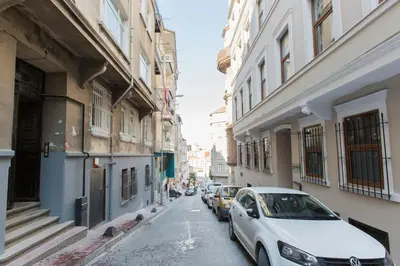 a white car parked on a street next to buildings at Architect Jonas generous 85 sqm apartment full of Art in Istanbul