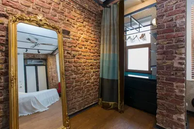 a mirror in a room with a brick wall at Architect Jonas generous 85 sqm apartment full of Art in Istanbul