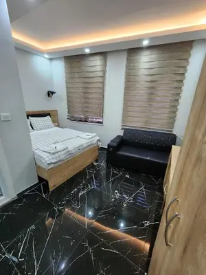 a room with a bed and a couch and windows at Acet Residence in Istanbul