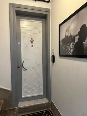 a door with a picture of a ship on the wall at ŞAHİN PERA SUİT2 Great location 2 Br air-conditioned apartment in Istanbul