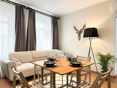 a living room with a table and a couch at ŞAHİN PERA SUİT2 Great location 2 Br air-conditioned apartment in Istanbul