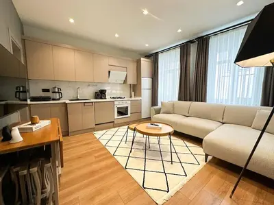 a living room with a couch and a table at ŞAHİN PERA SUİT2 Great location 2 Br air-conditioned apartment in Istanbul