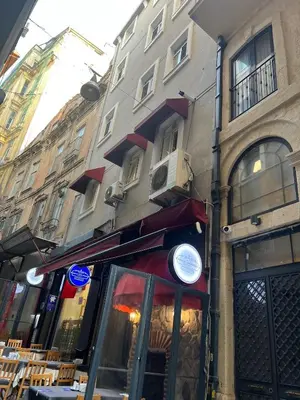 a restaurant on a street next to a building at ŞAHİN PERA SUİT2 Great location 2 Br air-conditioned apartment in Istanbul