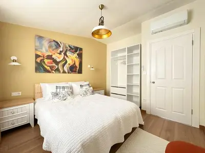 a bedroom with a bed and a painting on the wall at ŞAHİN PERA SUİT3 Central location 2 Br 3 Ac great apartment in Istanbul