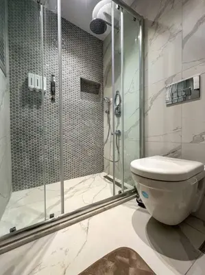 a bathroom with a glass shower and a toilet at ŞAHİN PERA SUİT3 Central location 2 Br 3 Ac great apartment in Istanbul