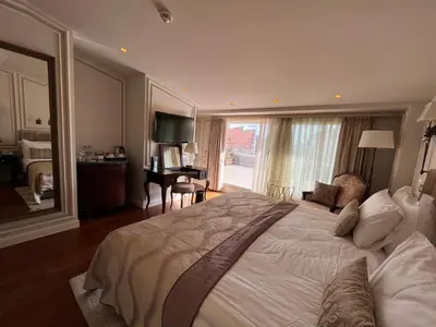a bedroom with a large bed with a large window at Arcade Hotel & SPA Nisantasi in Istanbul