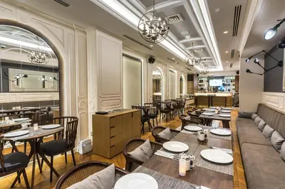 a restaurant with tables and chairs and a bar at Arcade Hotel & SPA Nisantasi in Istanbul