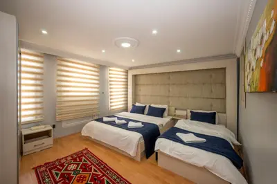 a bedroom with two beds with blue and white sheets at TAKSIM SUITE Apartment in Istanbul