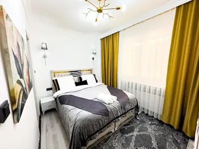 a bedroom with a bed and a window with yellow curtains at Sisli Apartments Holiday231 in Istanbul