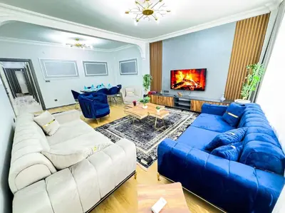 a living room with a blue couch and a blue sofa at Sisli Apartments Holiday441 in Istanbul