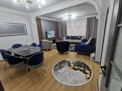 a living room with a table and chairs and a couch at Holiday 5 4 Sisli 3 in Istanbul
