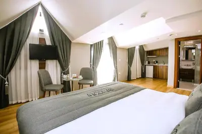 a hotel room with a bed and a table and chairs at Beyzas Hotels & Suites in Istanbul