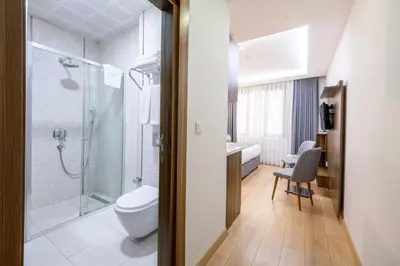 a bathroom with a shower and a toilet and a sink at Beyzas Hotels & Suites in Istanbul