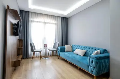 a living room with a blue couch and a table at Beyzas Hotels & Suites in Istanbul