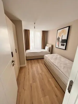 a small bedroom with two beds and a window at Sense Suite Residence-19 in Istanbul