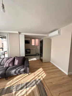 a living room with a couch and a kitchen at Sense Suite Residence-19 in Istanbul