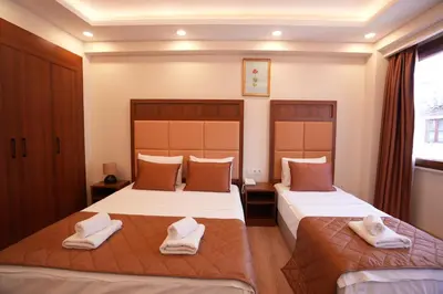 two beds in a hotel room with towels on them at Keeper in Istanbul