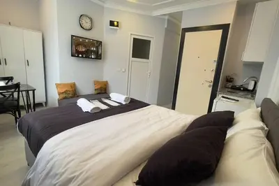 a bedroom with a large bed and a clock on the wall at Özdemir Apart - Sultanahmet in Istanbul