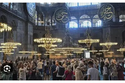 a large crowd of people in a large room with chandeliers at Özdemir Apart - Sultanahmet in Istanbul