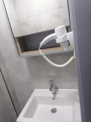 a bathroom with a white sink and a telephone at opera wall suite in Istanbul