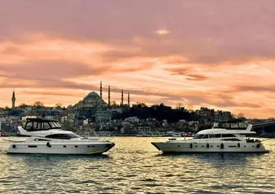 three boats in the water with a city in the background at Luxury Yachts Istanbul in Istanbul