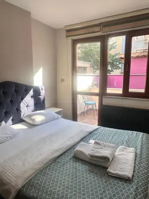 a bedroom with a large bed with two towels on it at Taksim Castle Suites in Istanbul