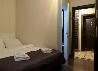 a room with a bed with two towels on it at Taksim Castle Suites in Istanbul