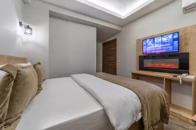 a bedroom with a bed and a flat screen tv at Beys Hotel Suites in Istanbul