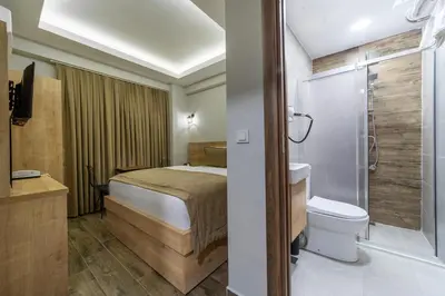 a bathroom with a bed and a toilet and a shower at Beys Hotel Suites in Istanbul