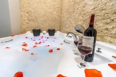 a bottle of wine sitting next to a glass of red wine at Beys Hotel Suites in Istanbul