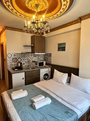 a bedroom with a bed with two towels on it at taksim white family suites in Istanbul