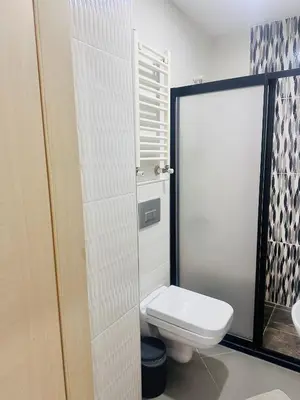 a bathroom with a white toilet and a sink at taksim white family suites in Istanbul