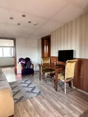 a living room with a table and a television at taksim white family suites in Istanbul