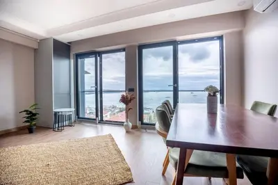 a dining room with a table and a view of the ocean at Modern Two-Bedroom Flat with Stunning Bosphorus View in Istanbul
