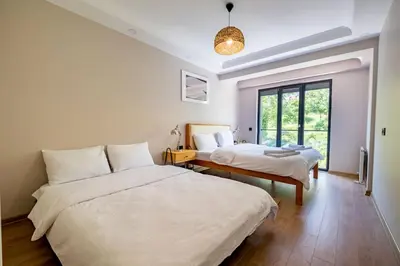 a bedroom with two beds and a window at Modern Two-Bedroom Flat with Stunning Bosphorus View in Istanbul