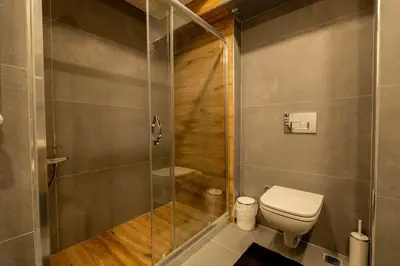 a bathroom with a toilet and a shower at Modern Two-Bedroom Flat with Stunning Bosphorus View in Istanbul
