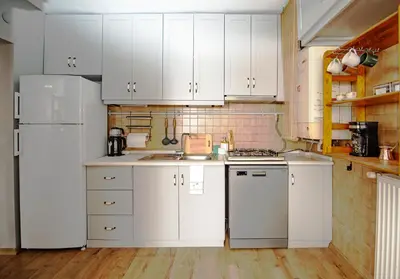 a kitchen with white cabinets and a white refrigerator at A Cozy, Quiet Home with Great View in City Center in Istanbul