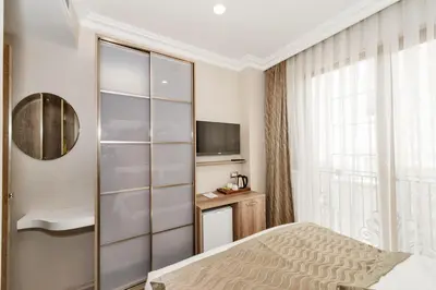a hotel room with a bed and a television at Alphonse Hotel in Istanbul