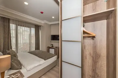 a bedroom with a bed and a window at Alphonse Hotel in Istanbul