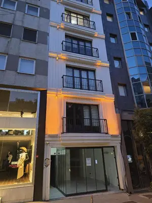 a tallartment building with windows and a store at NIŞANTAŞI JANTY LUXURY, 4 NEW APARTMENTs in Istanbul