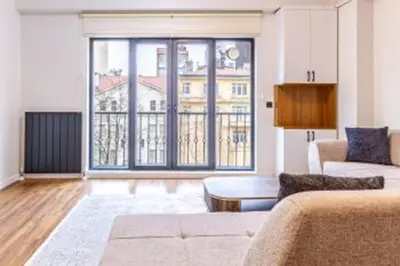 a living room with a couch and a large window at HEARTH OF DOWNTOWN ,LUXURY 1 NEW APARTMENTs in Istanbul