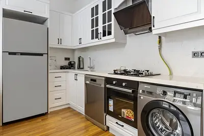 a kitchen with a washing machine and a washer at HEARTH OF DOWNTOWN ,LUXURY 1 NEW APARTMENTs in Istanbul